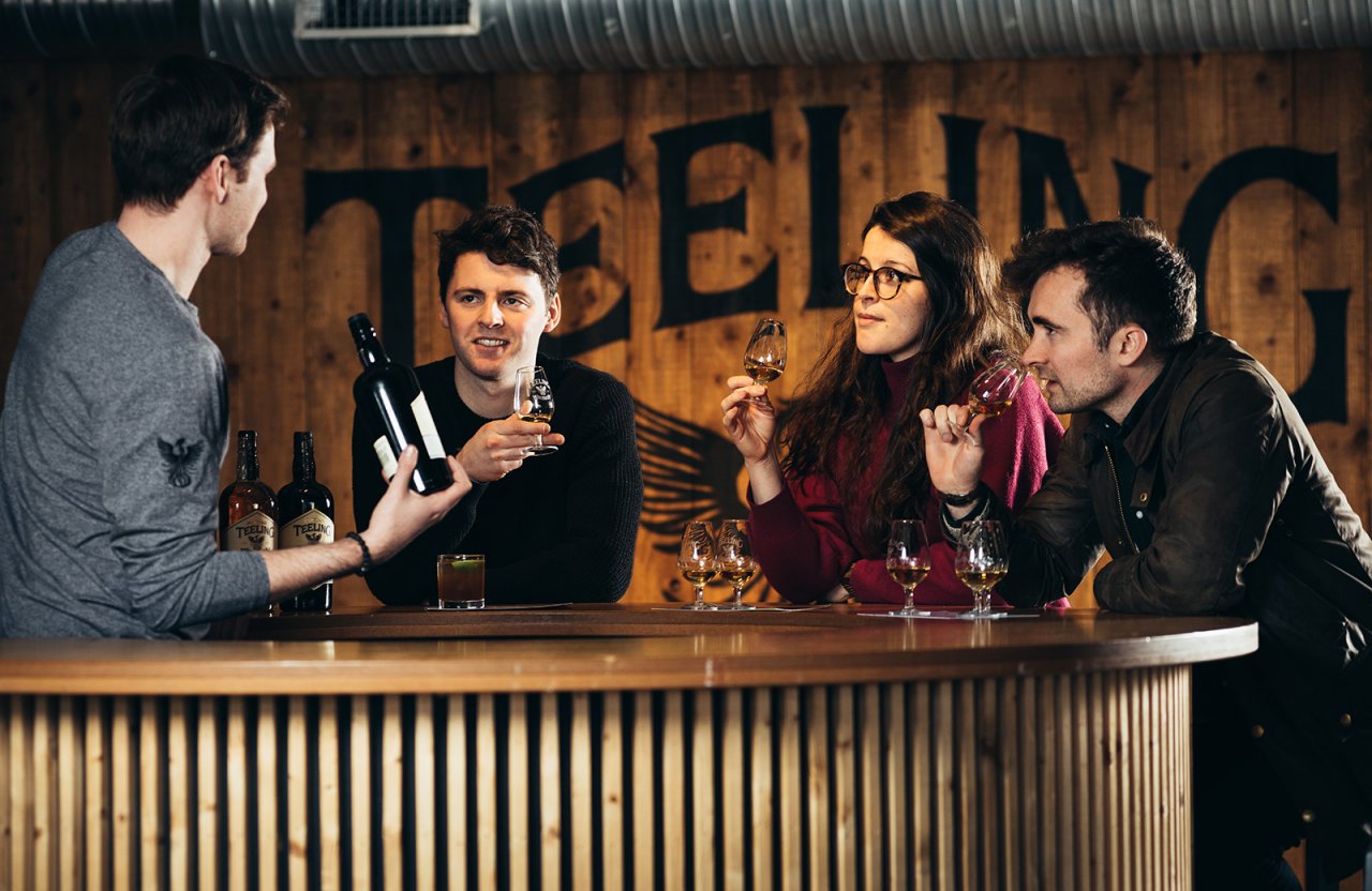 3 people tasting whiskey with barman